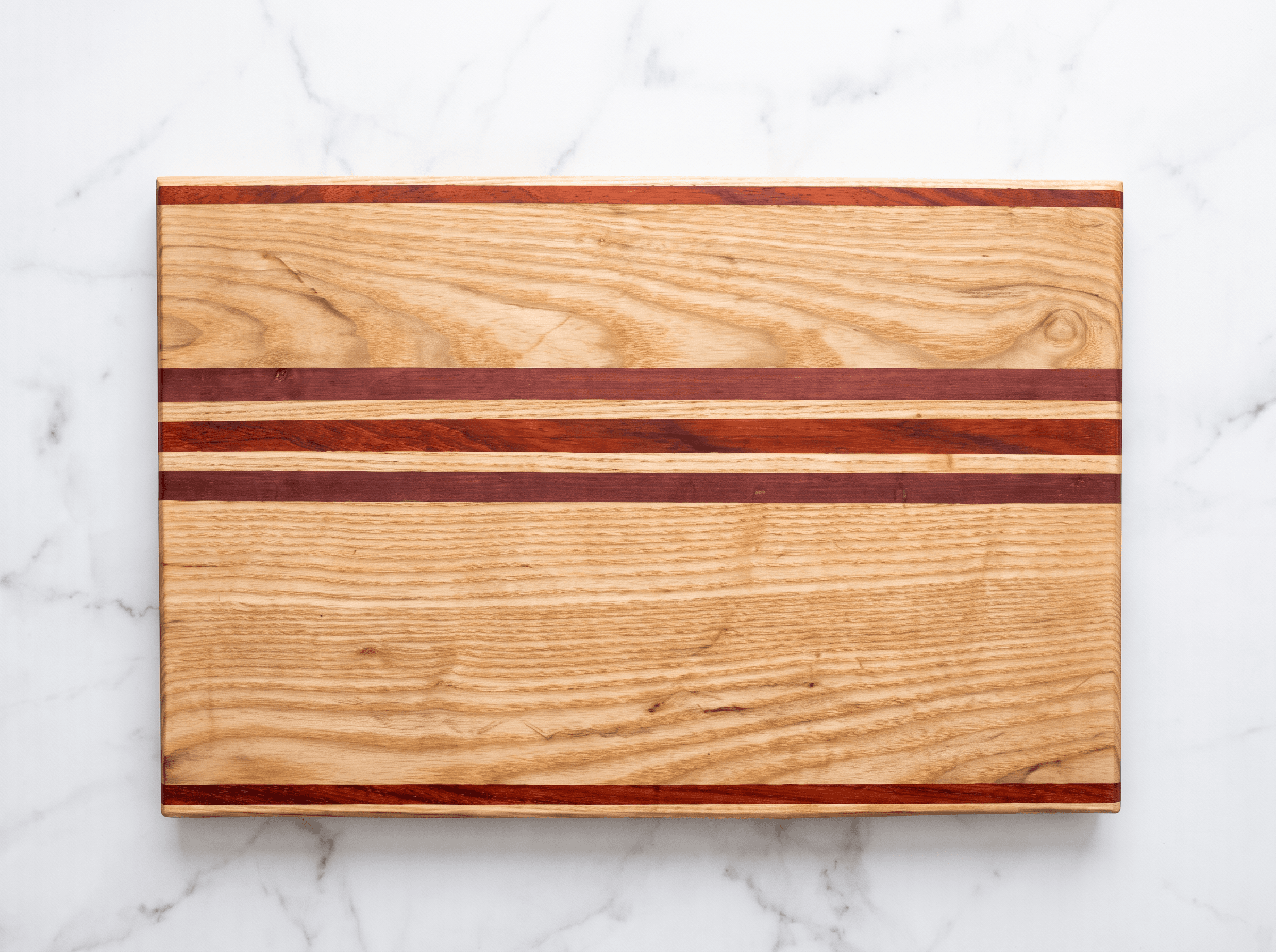 Contrasting oak and padauk timber selected for a striped board